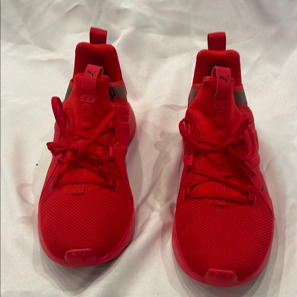 Never worn. Puma Red Sneakers with Mesh Upper and Streamlined Design